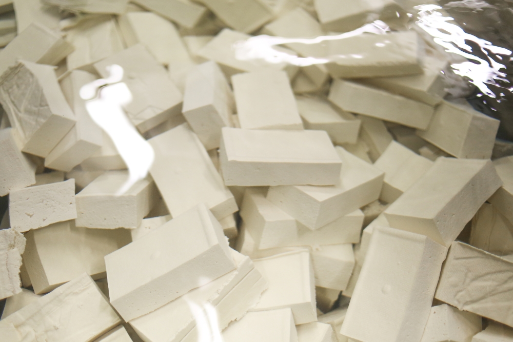 A close-up of blocks of tofu are cooled in water at Sunrise’s Vancouver facility.