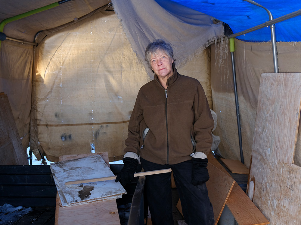 A woman in a large tent.
