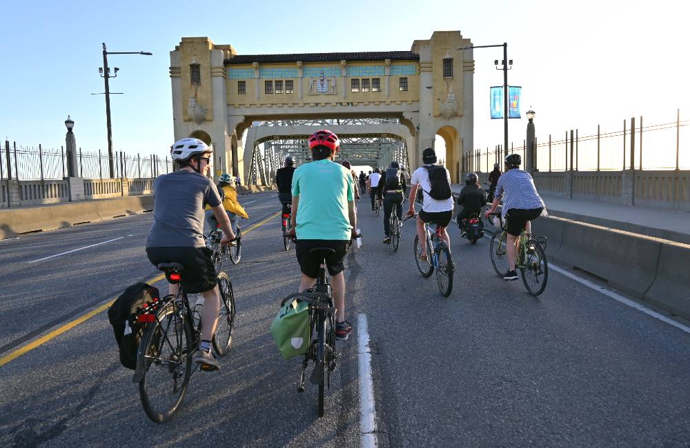 Various cyclists cross the Burrard Bridge on a clear Friday evening in Vancouver.