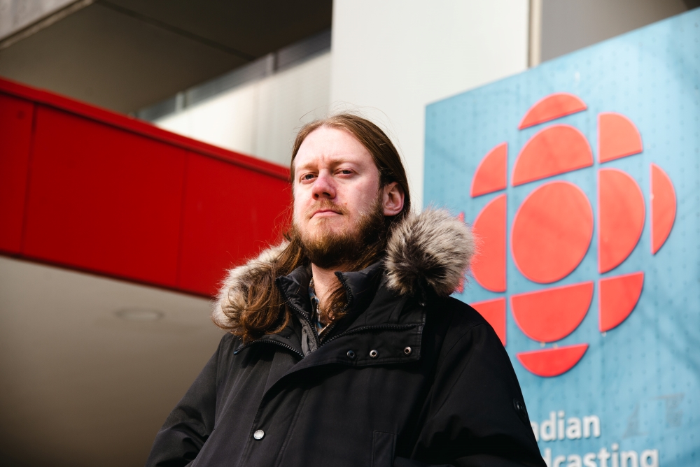 Julian Uzielli, producer for CBC Radio’s Podcast Playlist and the director for new members and precarious workers for CBC’s Toronto branch of the union from 2019 to 2020, stands outside the Wellington Street entrance of the CBC Toronto building.