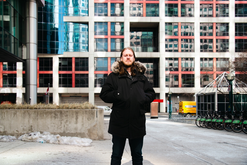 Julian Uzielli, a former lead organizer with the CBC temp collective, stands in front of CBC Toronto headquarters.