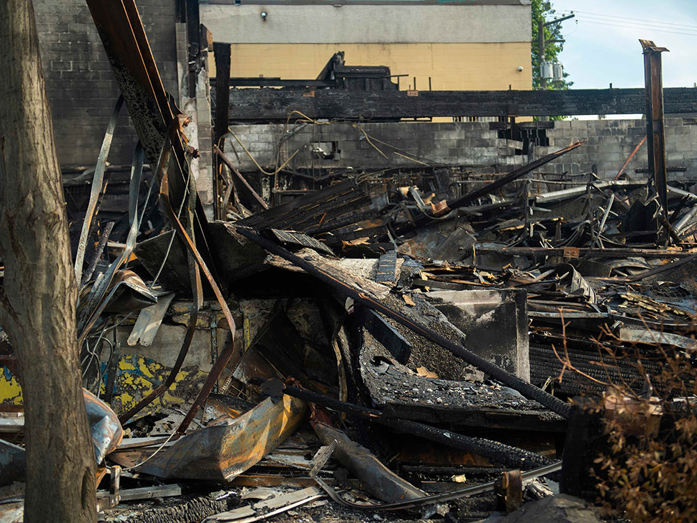 A photo of blackened, twisted ruins.