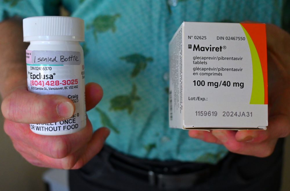 A man holds two types of Hep C medication people can be prescribed.