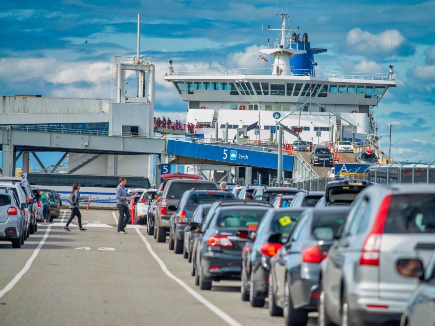 Cars lined up to board a BC ferry on a sunny day.