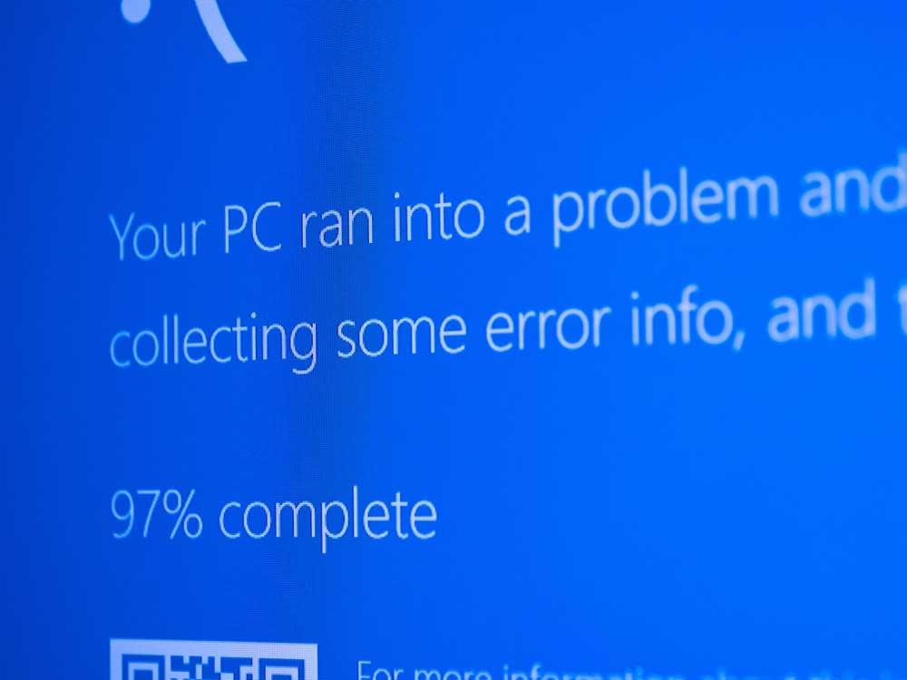 A blue screen reads, ‘Your PC ran into a problem and… collecting some error info...'