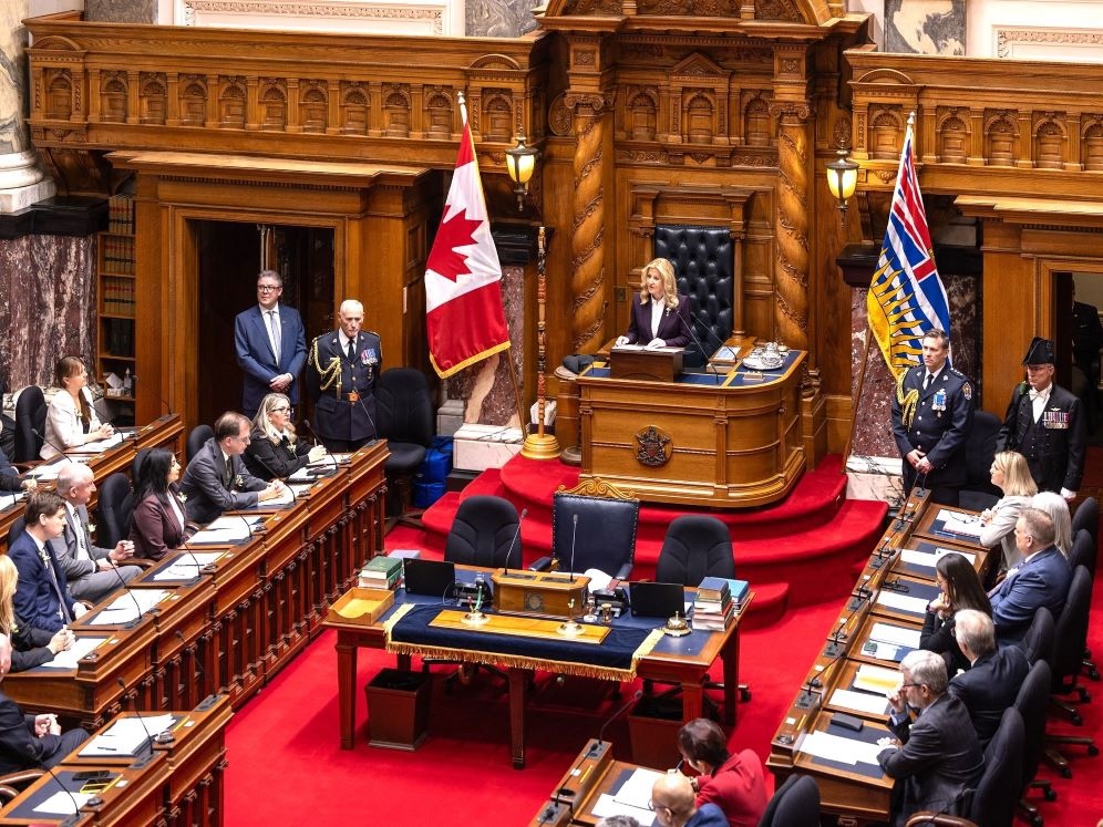 Lieutenant-Governor Wendy Cocchia, a woman with light skin tone and long blond hair, addresses MLAs inside the legislature.