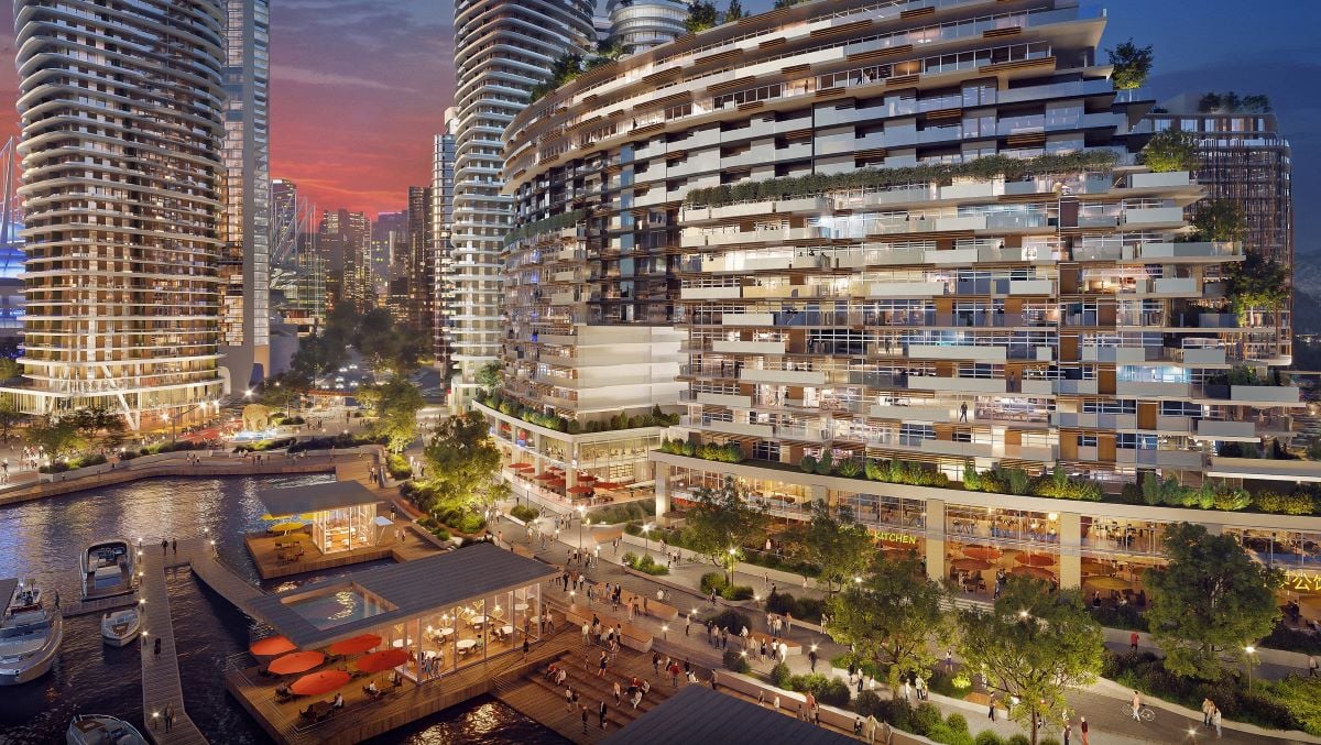 A rendering of a waterfront mixed-use development at dusk.