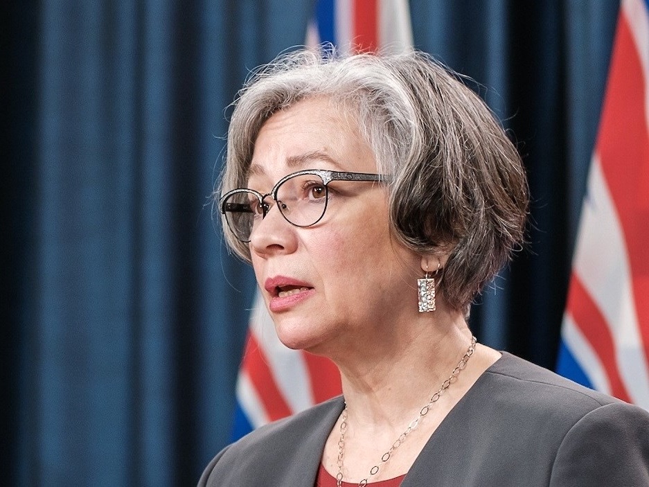 A grey-haired, light-skinned, 50-ish woman wearing jewelry speaks.