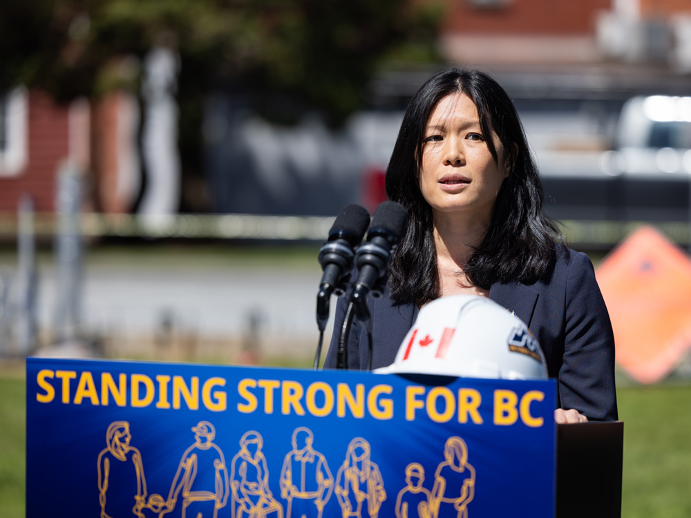 Bowinn Ma, a 39-year-old woman with medium-toned skin and shoulder length black hair, stands at a podium.