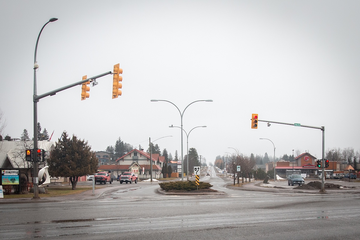 An intersection in a small town on a grey dreary day.