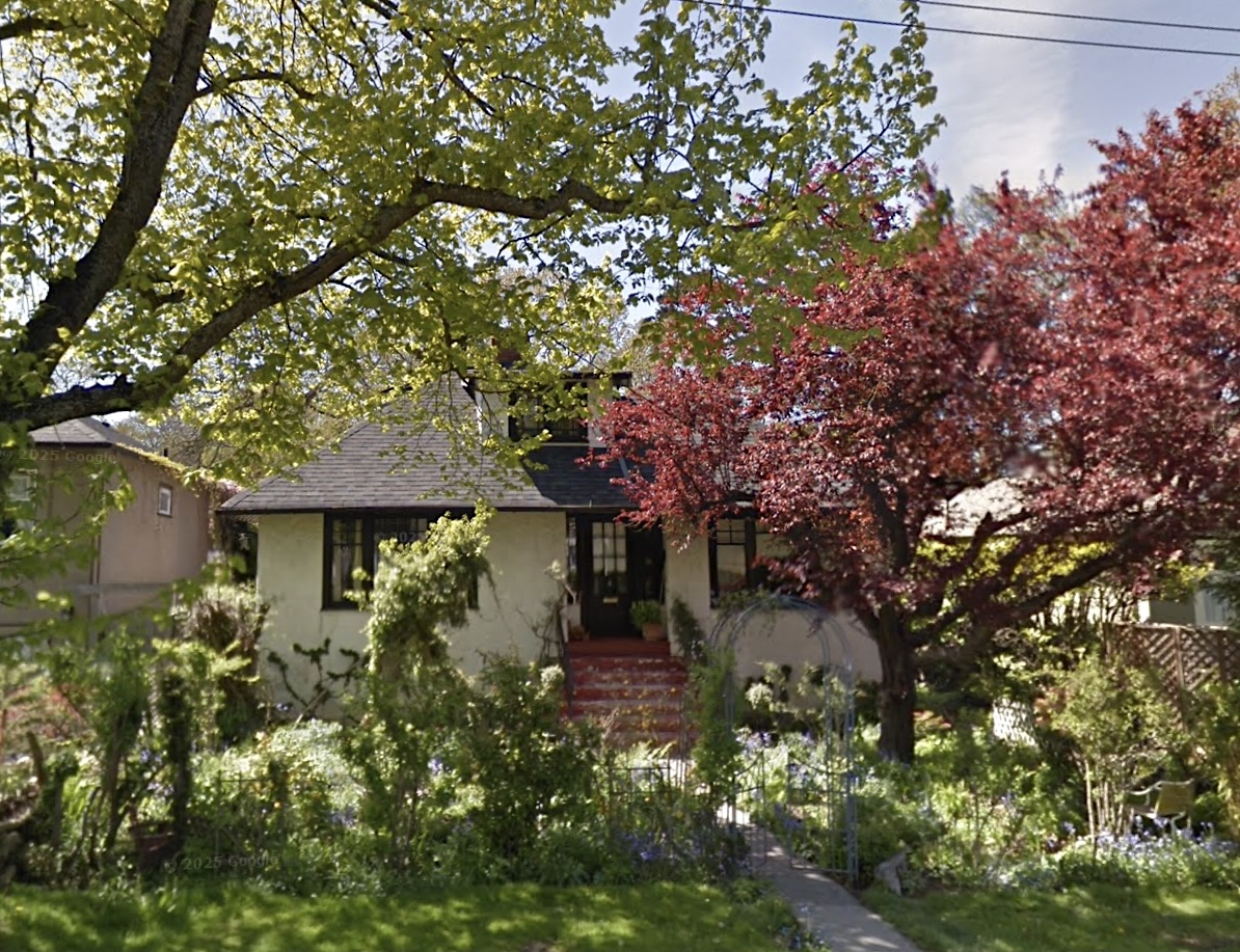 A photo shows a small house with a well-tended front garden.