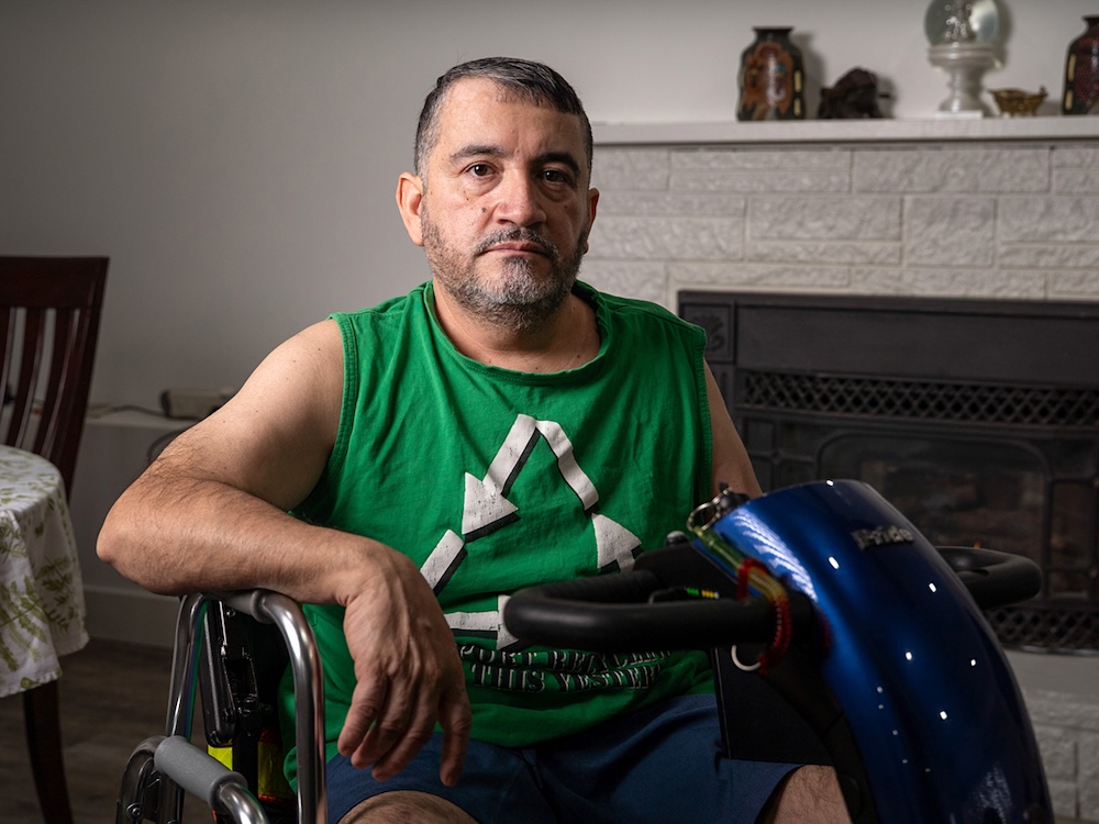 Francisco Barahona sits in a motorized scooter. 