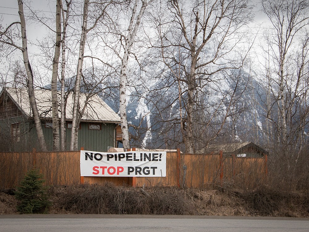 A house set against a mountainous backdrop has a sign in front that reads, &lsquo;No pipeline, stop PRGT.&rsquo;