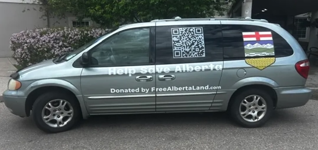 A grey minivan with a large bar code, the Alberta crest and &lsquo;Help Save Alberta&rsquo; on the side.