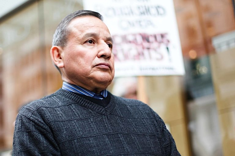 A grey-haired Indigenous man, Stewart Phillip, looks to the side.