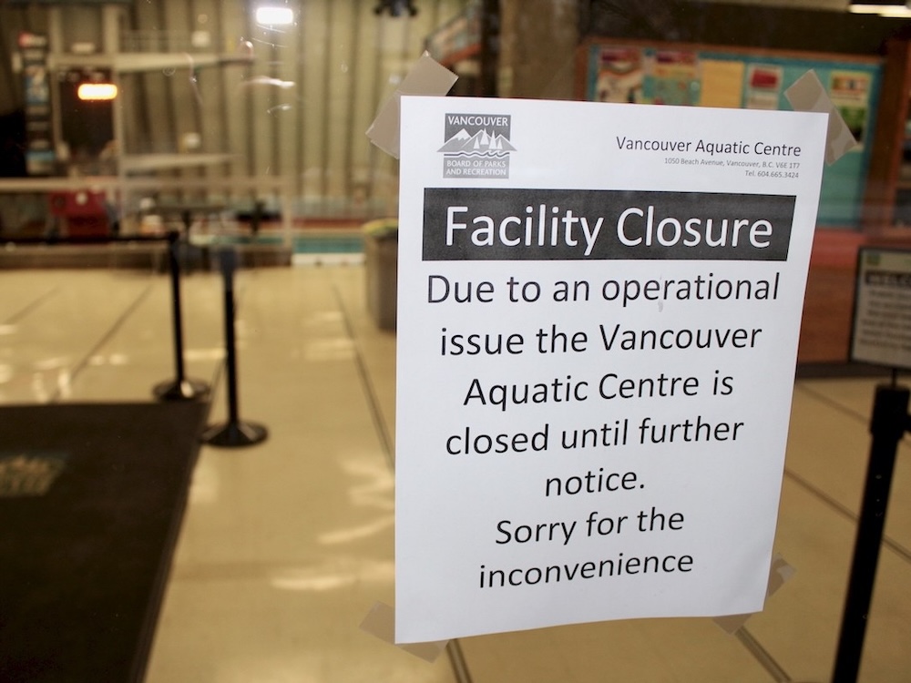 A sign taped to the glass window of an aquatic centre reads, &lsquo;Facility Closure. Due to an operational issue the Vancouver Aquatic Centre is closed until further notice. Sorry for the inconvenience.&rsquo;