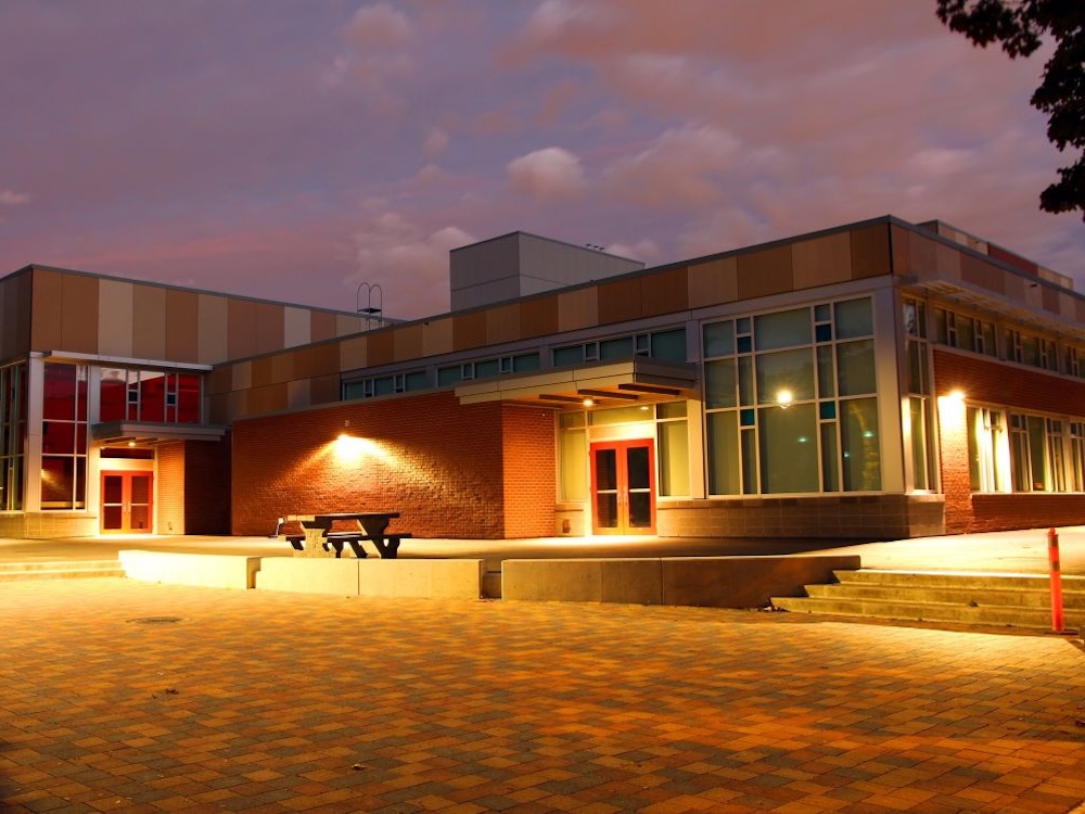 A one-story elementary school photographed at night.