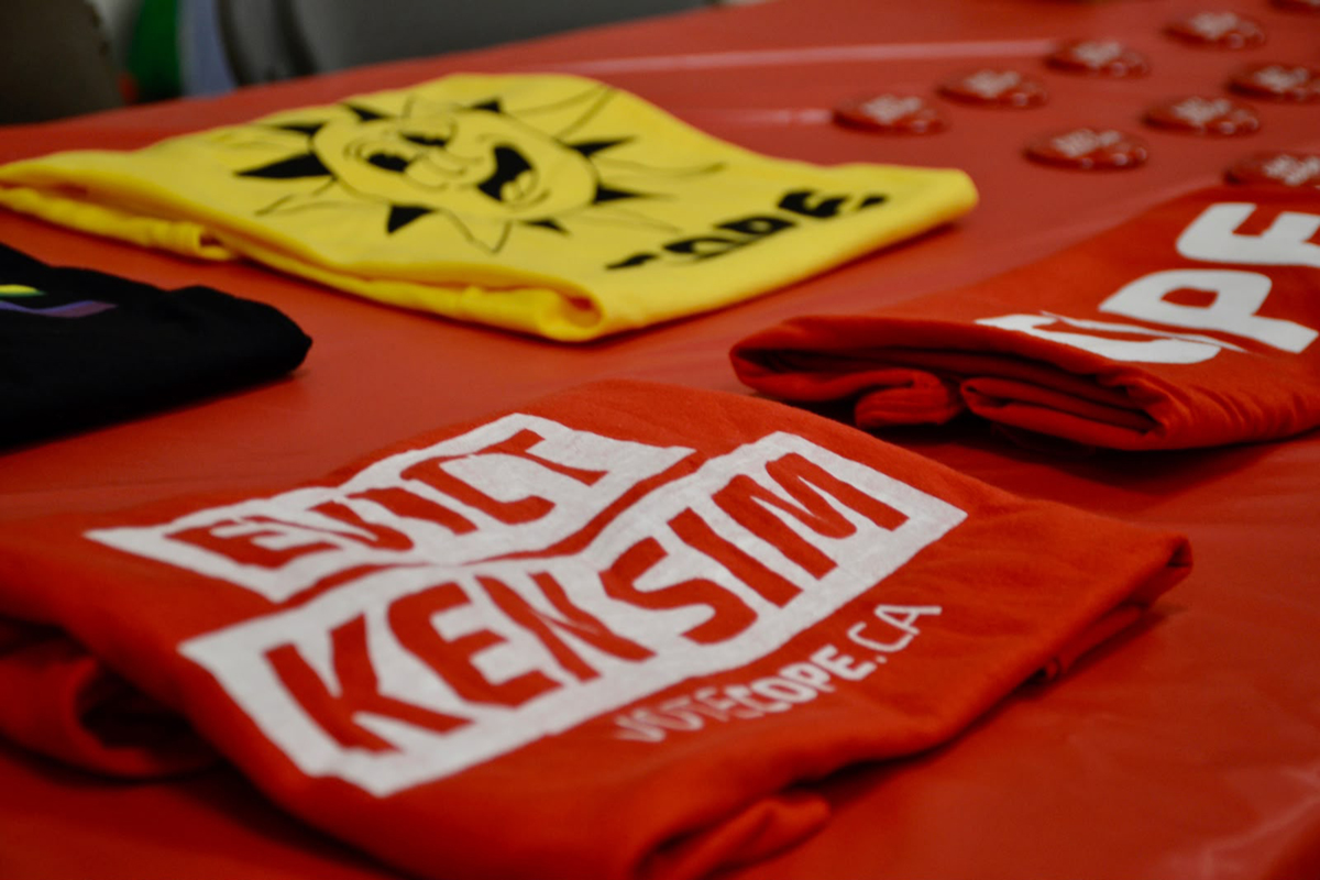 COPE produced buttons, T-shirts, and posters bearing the slogan “Evict Ken Sim” several weeks before election day. Photo for The Tyee: Josh Kozelj.