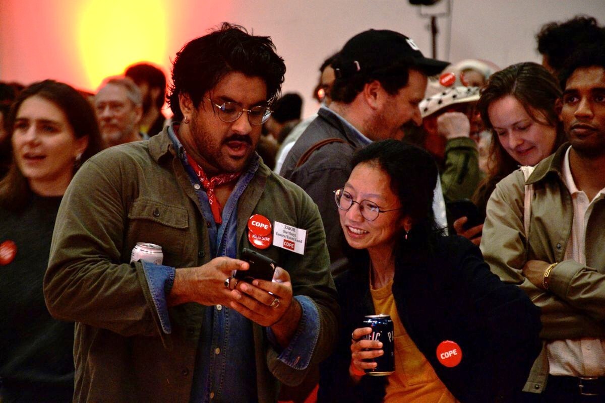 COPE supporters react to the first results coming in live. Photo for The Tyee: Josh Kozelj.