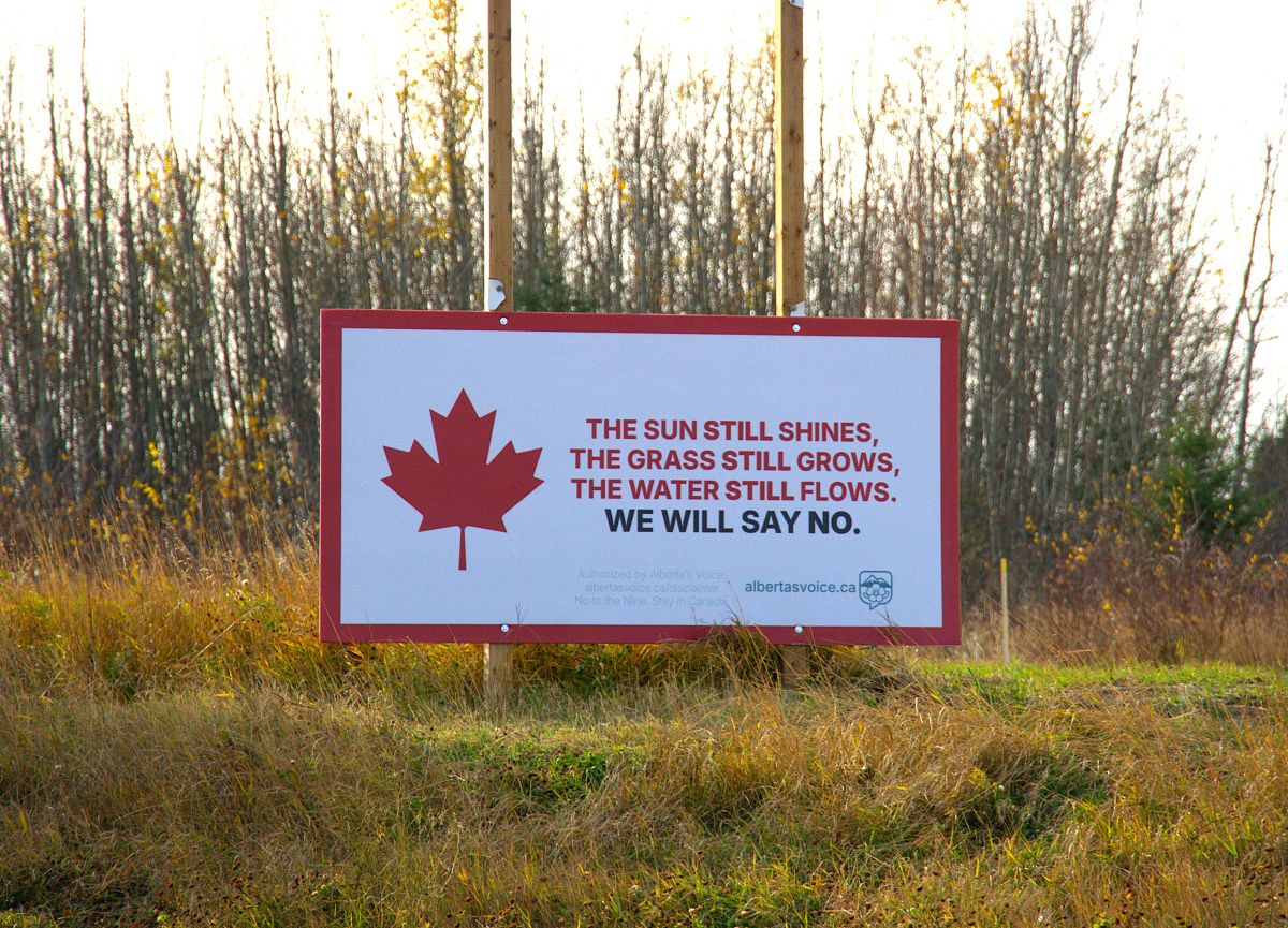 A sign in a grassy area says, to paraphrase, that nature perseveres and Alberta will stay in Canada.