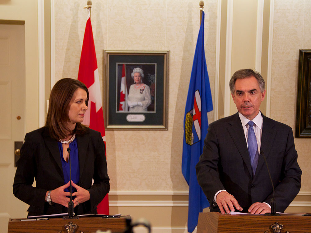 Danielle Smith and Jim Prentice on Dec. 14 as they announce the floor crossings of Ms. Smith and eight Wildrose MLAs to the governing PC Party caucus.