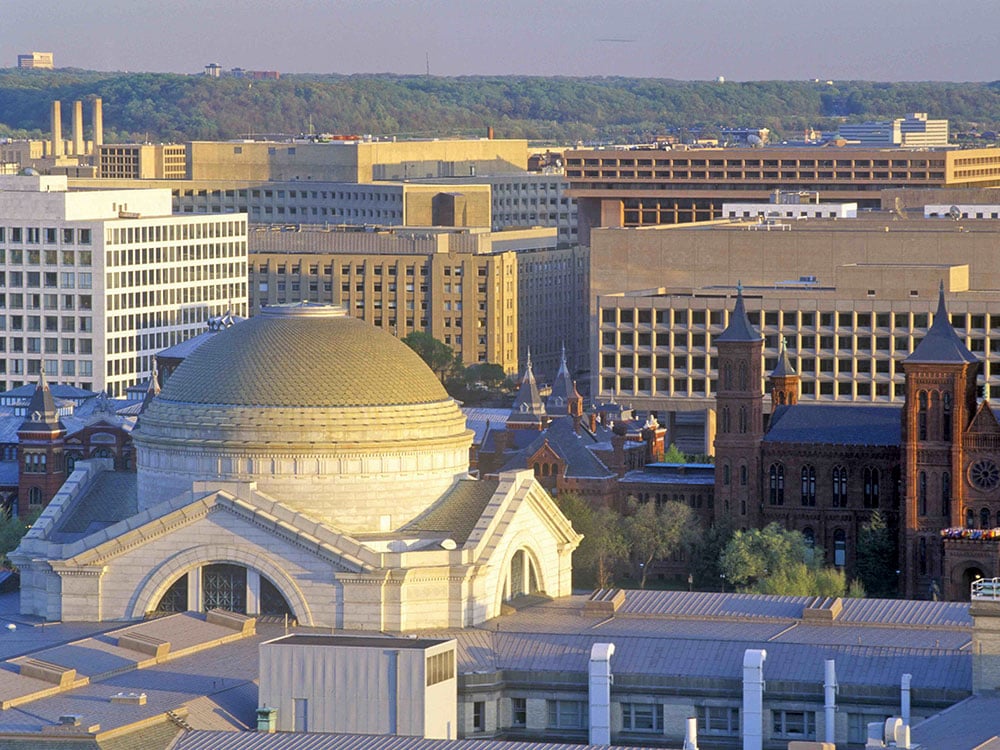 A view of the Smithsonian National Museum of Natural History (the white building with the dome, left) and the Smithsonian Institution (the brown castle-like building, right) in Washington, D.C.
