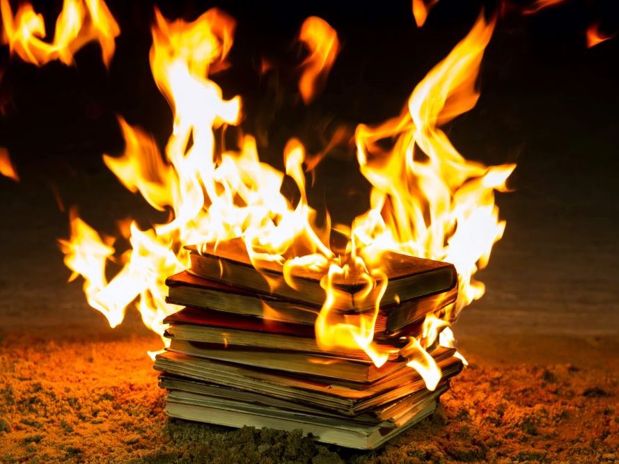 A pile of books is in flames.