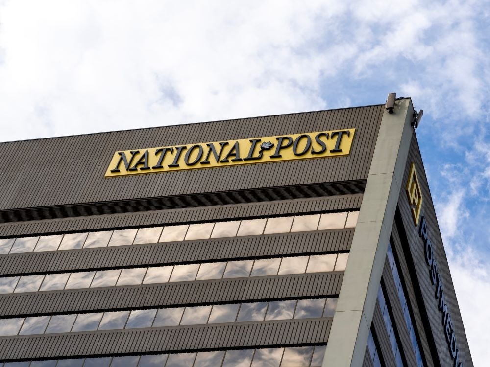 A brown office building with a ‘National Post’ sign on it.