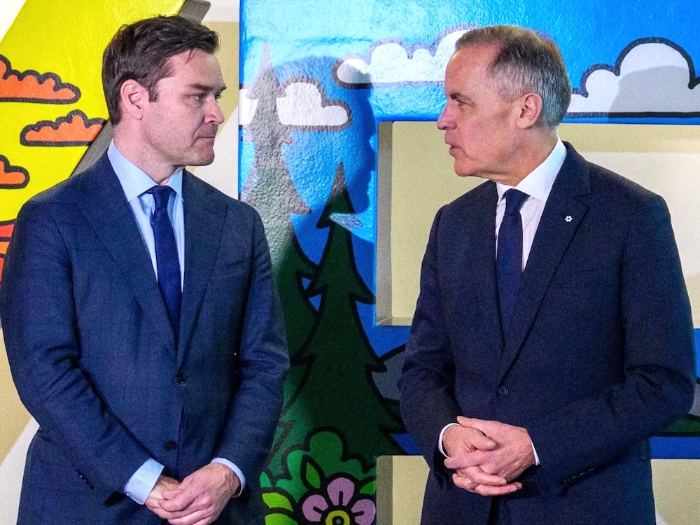 Matt Jeneroux, on the left, stands with Mark Carney.