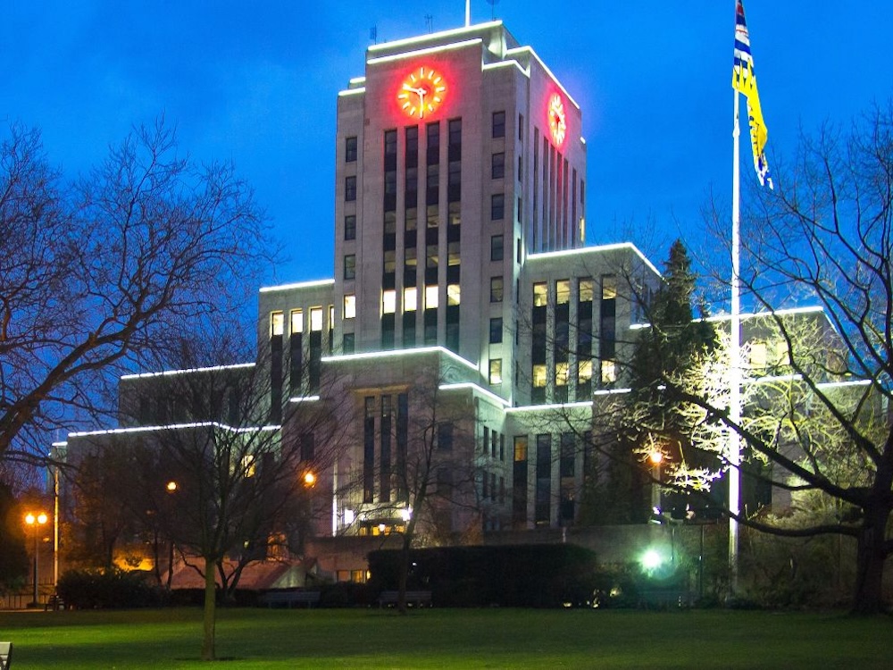 A photo of Vancouver city hall lit up at night.