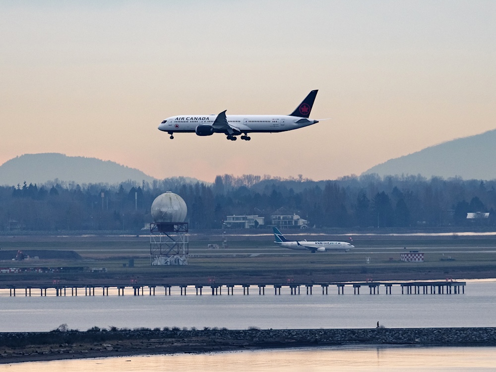 An Air Canada Boeing 787-9 Dreamliner jetliner airborne on approach for landing at Vancouver International Airport.