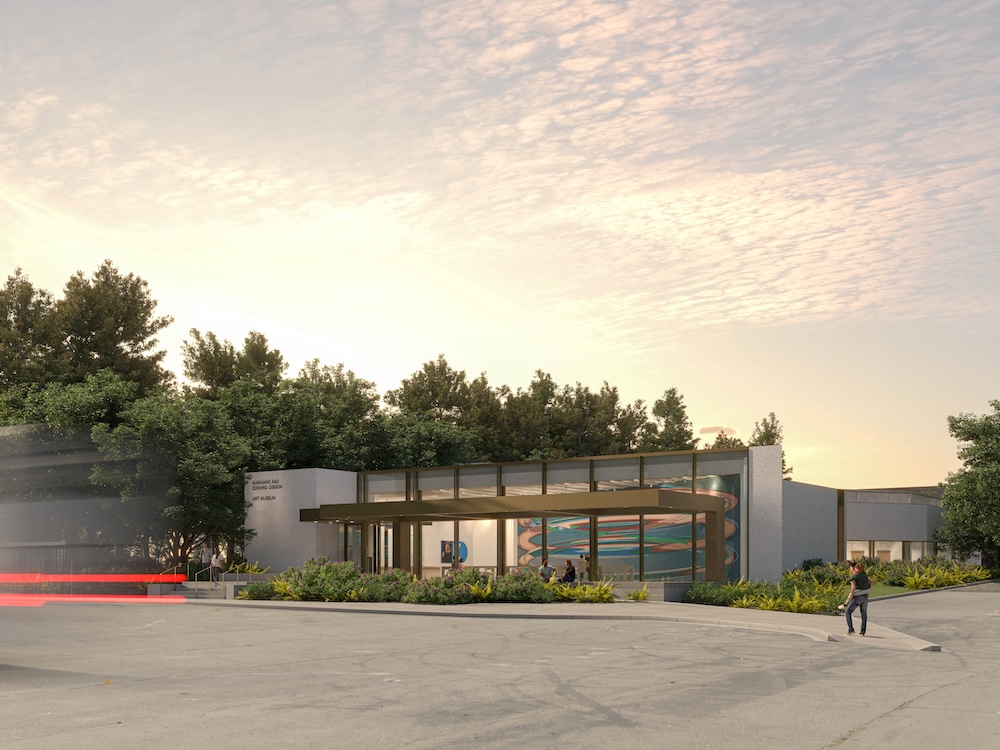 This rendered image of the Gibson Art Museum features a flat-roofed, contemporary building with a grey exterior and glass windows. A person walks toward it, and the sky is speckled with pink clouds.