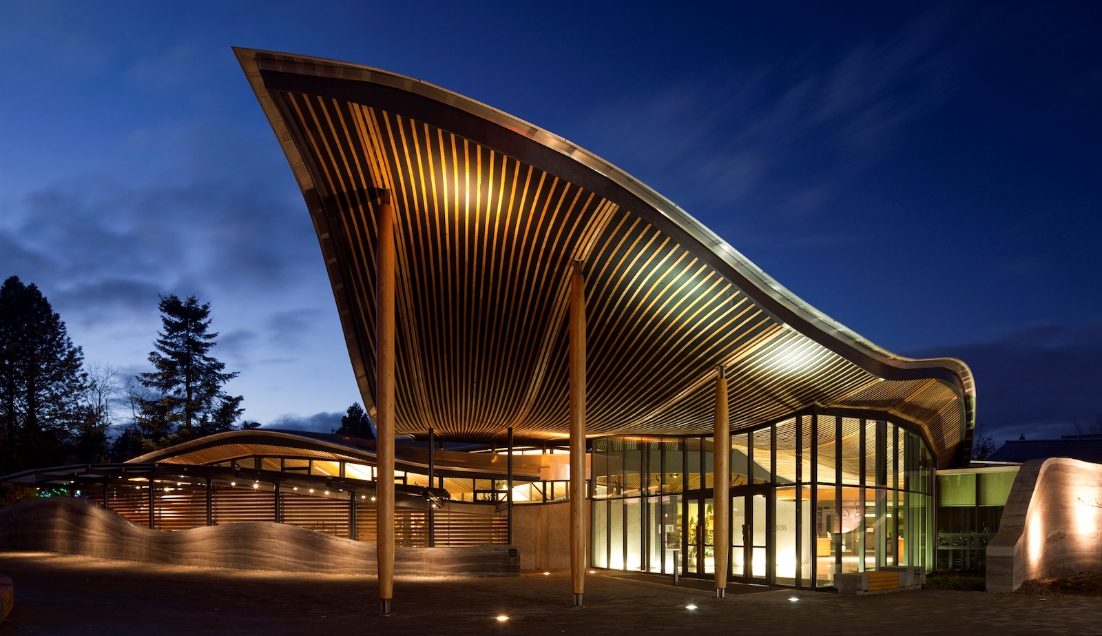 A visitors pavilion with a wooden roof that curves elegantly.