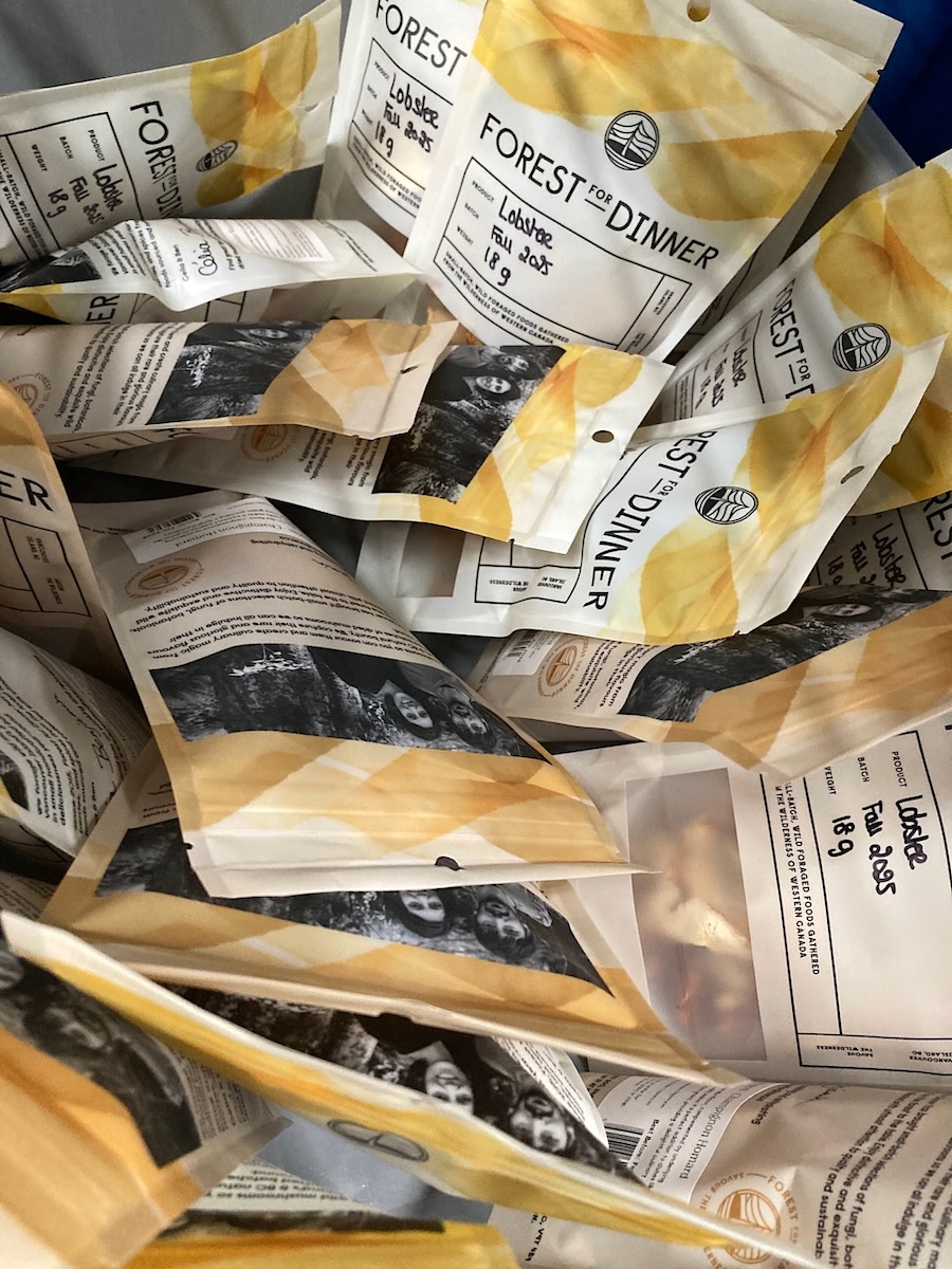 A handful of white and yellow bags labelled &lsquo;Forest for Dinner&rsquo; sit in a box.