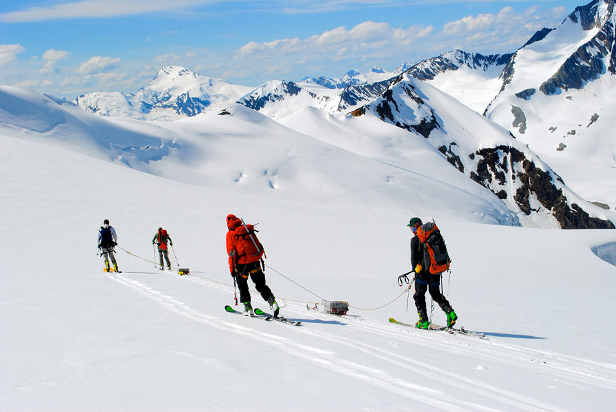 Glaciologists skiing through the mountains